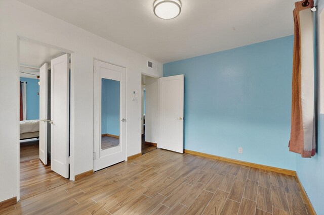7719 Euclid Ave NE, Albuquerque, NM 87110 - unfurnished bedroom featuring light wood-style flooring and baseboards