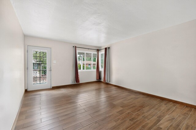 7719 Euclid Ave NE, Albuquerque, NM 87110 - spare room with baseboards and wood finished floors