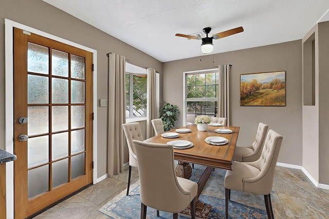 1519 Lundy Ln SW, Albuquerque, NM 87105 - dining space with ceiling fan and light stone finish flooring