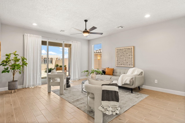 2520 Guadalupe Rd NE, Rio Rancho, NM 87144 - living room with a ceiling fan, light wood-style floors, a textured ceiling, and recessed lighting