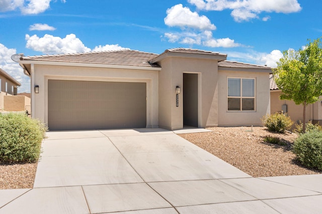 2520 Guadalupe Rd NE, Rio Rancho, NM 87144 - view of front of property with a garage, driveway, and stucco siding