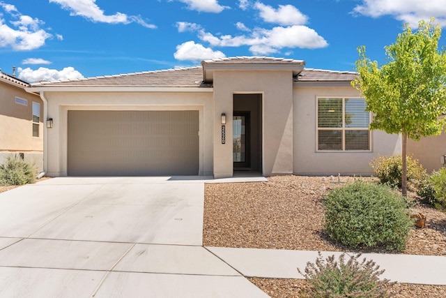 2520 Guadalupe Rd NE, Rio Rancho, NM 87144 - view of front of house with an attached garage, driveway, stucco siding, and a tiled roof