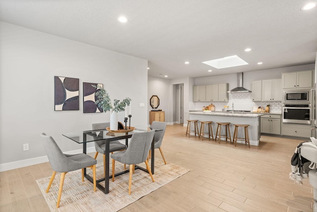 2520 Guadalupe Rd NE, Rio Rancho, NM 87144 - dining room with a skylight, light wood finished floors, and recessed lighting
