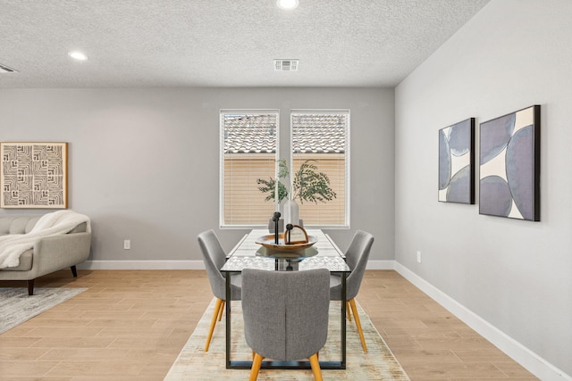 2520 Guadalupe Rd NE, Rio Rancho, NM 87144 - dining area with light wood-style flooring, recessed lighting, and a textured ceiling