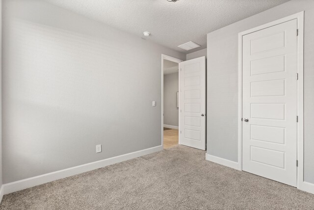 2520 Guadalupe Rd NE, Rio Rancho, NM 87144 - unfurnished bedroom featuring light colored carpet and a textured ceiling