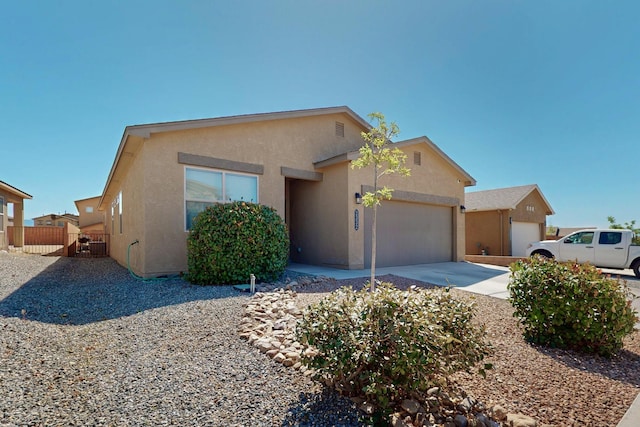 2332 Del Timbre Ln SW, Albuquerque, NM 87121 - view of front of property with stucco siding, a garage, and concrete driveway