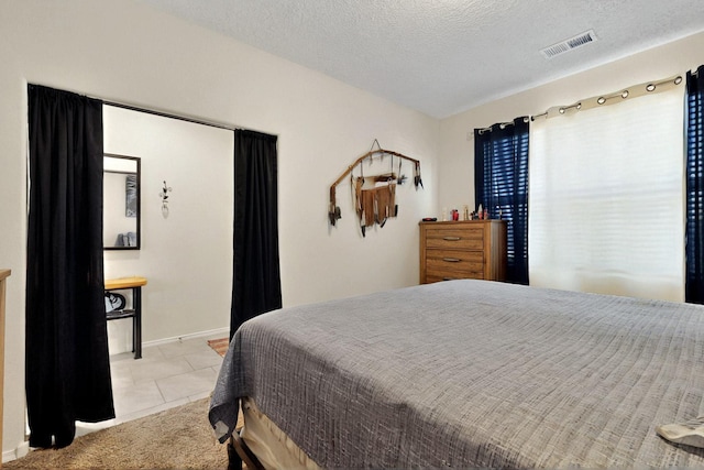 2332 Del Timbre Ln SW, Albuquerque, NM 87121 - bedroom with light tile patterned floors and a textured ceiling