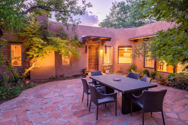2505 Elfego Rd NW, Albuquerque, NM 87107 - patio terrace at dusk with a patio and outdoor dining space