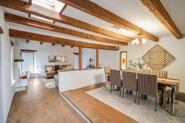 2505 Elfego Rd NW, Albuquerque, NM 87107 - dining room with brick patterned flooring, beam ceiling, and a chandelier