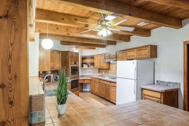 2505 Elfego Rd NW, Albuquerque, NM 87107 - kitchen with stainless steel appliances, tile counters, open shelves, a wood ceiling with exposed beams, and decorative backsplash