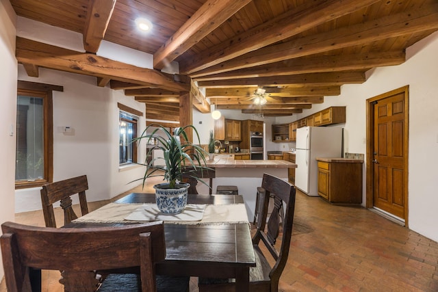2505 Elfego Rd NW, Albuquerque, NM 87107 - dining space featuring a wood ceiling with exposed beams, brick floors, ceiling fan, and recessed lighting