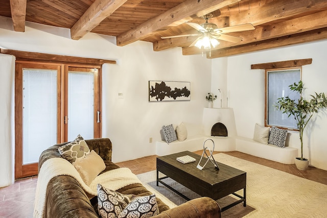 2505 Elfego Rd NW, Albuquerque, NM 87107 - living area with a wooden ceiling with exposed beams, a ceiling fan, light tile patterned floors, and healthy amount of natural light