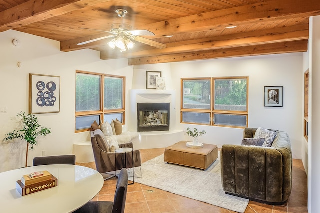 2505 Elfego Rd NW, Albuquerque, NM 87107 - living area with a wood ceiling with exposed beams, tile patterned flooring, ceiling fan, and a fireplace with raised hearth