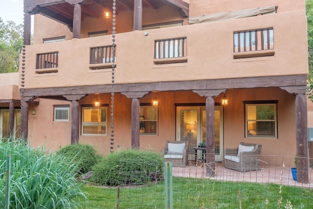 2505 Elfego Rd NW, Albuquerque, NM 87107 - back of house with a balcony and stucco siding