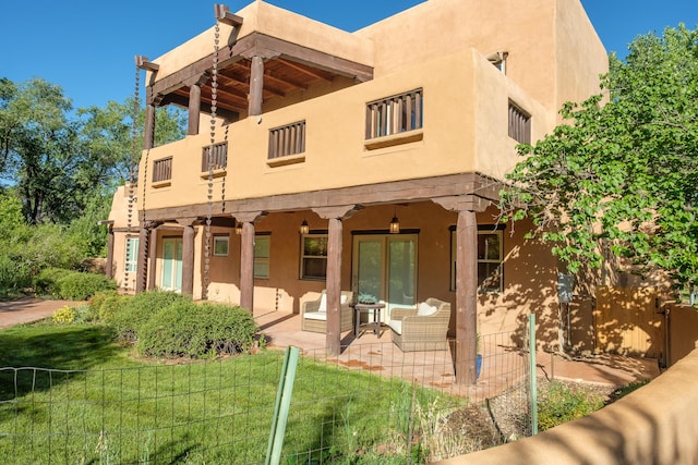 2505 Elfego Rd NW, Albuquerque, NM 87107 - back of house with stucco siding, a balcony, and a patio