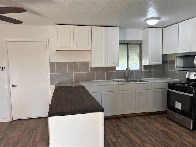 714 Locust St, Clayton, NM 88415 - kitchen with stainless steel appliances, dark wood finished floors, tasteful backsplash, and a textured ceiling