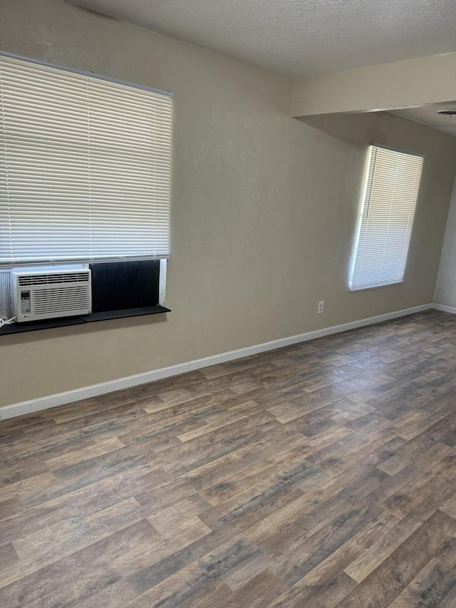 714 Locust St, Clayton, NM 88415 - spare room with wood finished floors and a textured ceiling