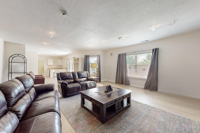 4104 Killington Rd NW, Albuquerque, NM 87114 - living area with a textured ceiling and light wood-style flooring
