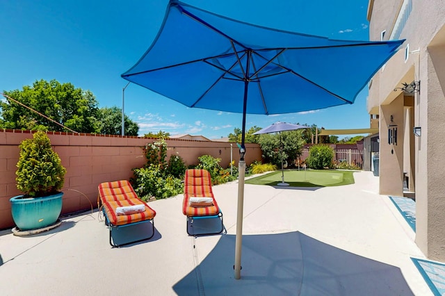 4104 Killington Rd NW, Albuquerque, NM 87114 - fenced backyard with a putting area and a patio