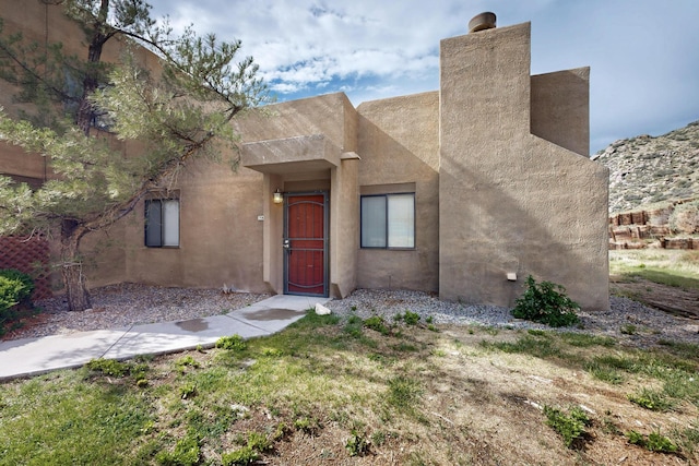 2900 Vista Del Rey NE Unit 7A, Albuquerque, NM 87112 - view of front of home with stucco siding and a chimney