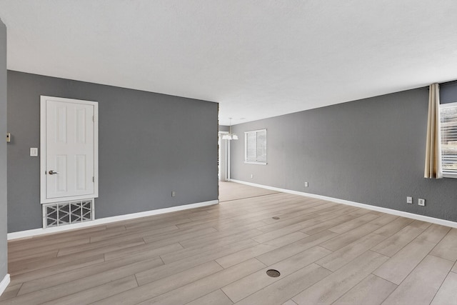 2900 Vista Del Rey NE Unit 7A, Albuquerque, NM 87112 - unfurnished room featuring wood finished floors and a chandelier