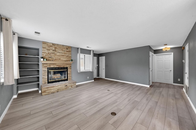 2900 Vista Del Rey NE Unit 7A, Albuquerque, NM 87112 - unfurnished living room with wood finished floors and a stone fireplace