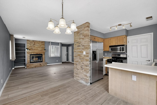 2900 Vista Del Rey NE Unit 7A, Albuquerque, NM 87112 - kitchen featuring appliances with stainless steel finishes, open floor plan, a chandelier, light countertops, and light wood-type flooring
