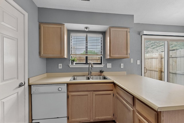 2900 Vista Del Rey NE Unit 7A, Albuquerque, NM 87112 - kitchen featuring white dishwasher, a peninsula, light brown cabinets, light countertops, and plenty of natural light