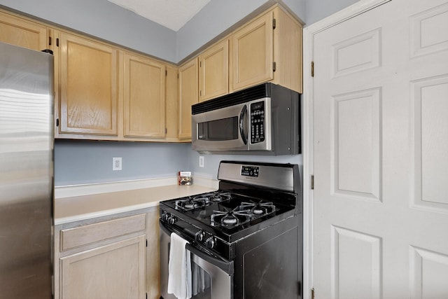 2900 Vista Del Rey NE Unit 7A, Albuquerque, NM 87112 - kitchen with appliances with stainless steel finishes, light brown cabinets, and light countertops
