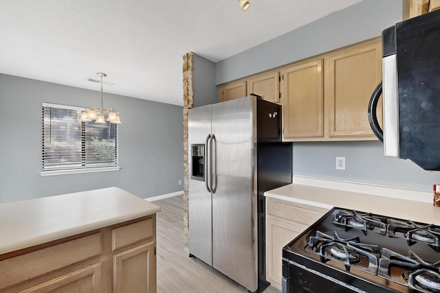 2900 Vista Del Rey NE Unit 7A, Albuquerque, NM 87112 - kitchen with appliances with stainless steel finishes, light brown cabinets, light countertops, light wood-style flooring, and a chandelier