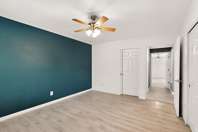 2900 Vista Del Rey NE Unit 7A, Albuquerque, NM 87112 - unfurnished bedroom with light wood finished floors and a ceiling fan