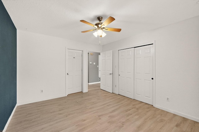 2900 Vista Del Rey NE Unit 7A, Albuquerque, NM 87112 - unfurnished bedroom featuring light wood-type flooring, ceiling fan, and a closet