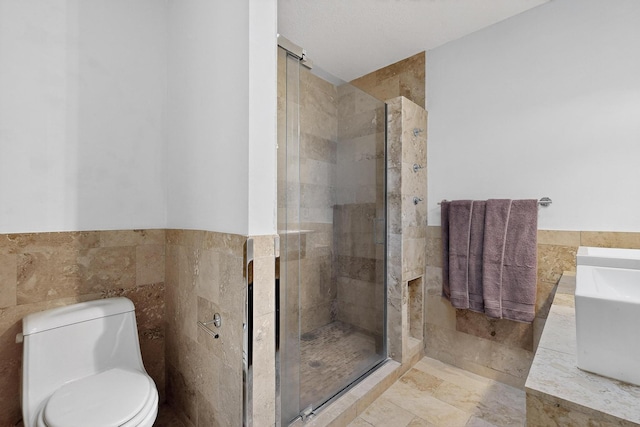2900 Vista Del Rey NE Unit 7A, Albuquerque, NM 87112 - bathroom with tile walls, a shower stall, and wainscoting