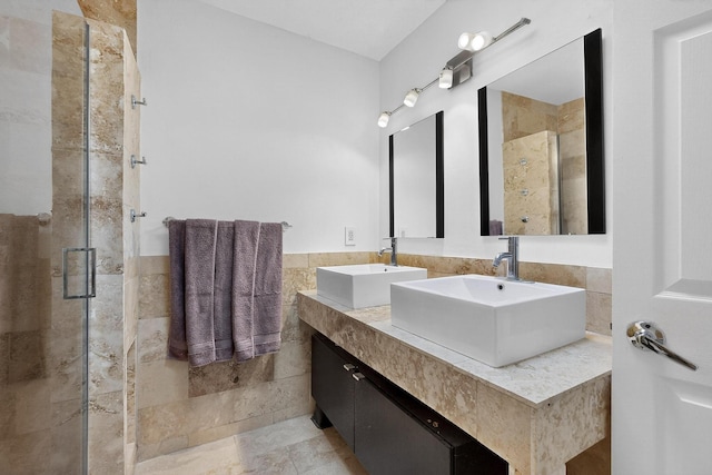 2900 Vista Del Rey NE Unit 7A, Albuquerque, NM 87112 - bathroom with tile walls, a stall shower, two vanities, and wainscoting