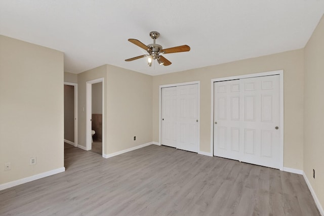 2900 Vista Del Rey NE Unit 7A, Albuquerque, NM 87112 - unfurnished bedroom with multiple closets, light wood-style floors, and a ceiling fan