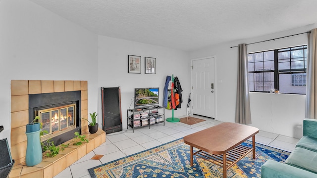 6041 Sequoia Rd NW Unit B3, Albuquerque, NM 87120 - living area featuring a tile fireplace, light tile patterned flooring, and a textured ceiling