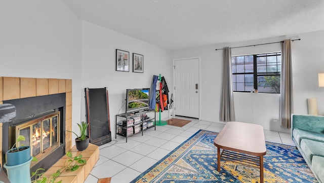 6041 Sequoia Rd NW Unit B3, Albuquerque, NM 87120 - living area featuring a textured ceiling, a tiled fireplace, and light tile patterned floors