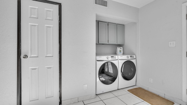 6041 Sequoia Rd NW Unit B3, Albuquerque, NM 87120 - washroom featuring separate washer and dryer, light tile patterned flooring, and cabinet space