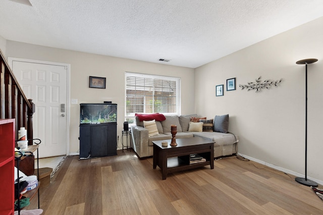 700 Fruit Ave NW Unit G, Albuquerque, NM 87102 - living area featuring wood finished floors, a textured ceiling, and stairway