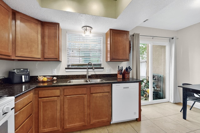 700 Fruit Ave NW Unit G, Albuquerque, NM 87102 - kitchen with dishwasher, stove, brown cabinetry, and a textured ceiling