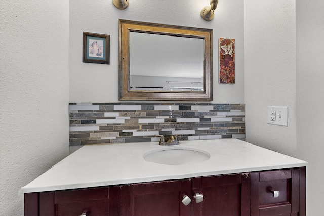 700 Fruit Ave NW Unit G, Albuquerque, NM 87102 - bathroom featuring vanity, decorative backsplash, and a textured wall