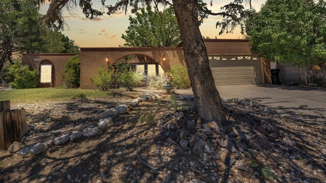 13101 Comanche Rd NE, Albuquerque, NM 87111 - view of front of house with concrete driveway and a garage