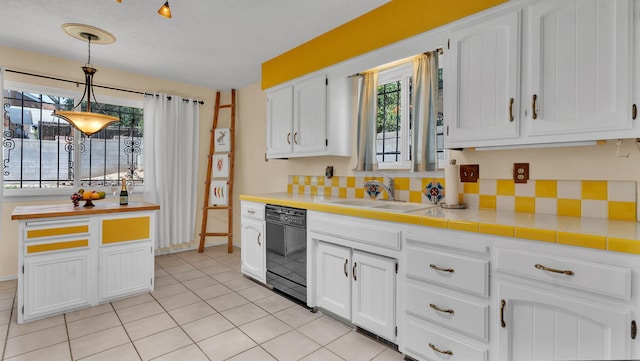 13101 Comanche Rd NE, Albuquerque, NM 87111 - kitchen with dishwasher, healthy amount of natural light, and white cabinets