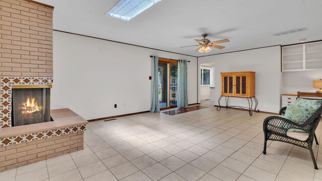 13101 Comanche Rd NE, Albuquerque, NM 87111 - unfurnished living room featuring tile patterned floors, a ceiling fan, and a fireplace