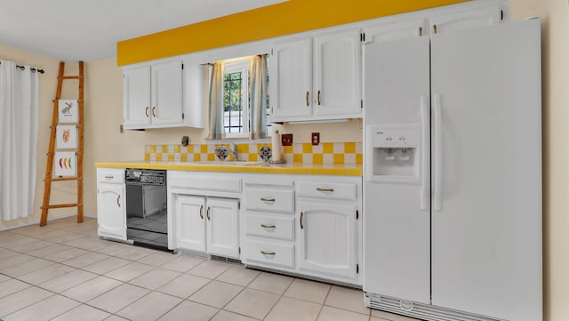 13101 Comanche Rd NE, Albuquerque, NM 87111 - kitchen with white fridge with ice dispenser, black dishwasher, tile counters, white cabinetry, and light tile patterned floors