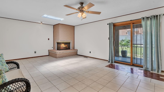 13101 Comanche Rd NE, Albuquerque, NM 87111 - unfurnished living room featuring light tile patterned flooring, a ceiling fan, and a brick fireplace