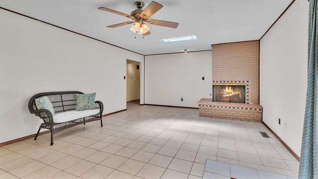 13101 Comanche Rd NE, Albuquerque, NM 87111 - sitting room with a ceiling fan, a fireplace, and light tile patterned flooring