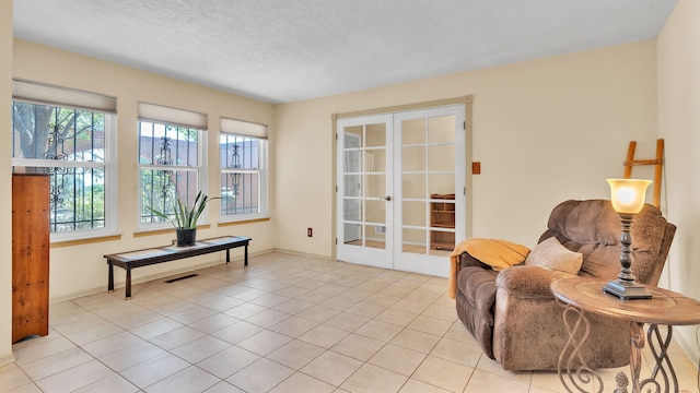13101 Comanche Rd NE, Albuquerque, NM 87111 - living area with french doors, light tile patterned floors, and a textured ceiling