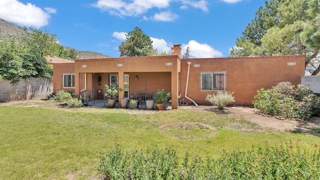 13101 Comanche Rd NE, Albuquerque, NM 87111 - rear view of house featuring stucco siding and a chimney
