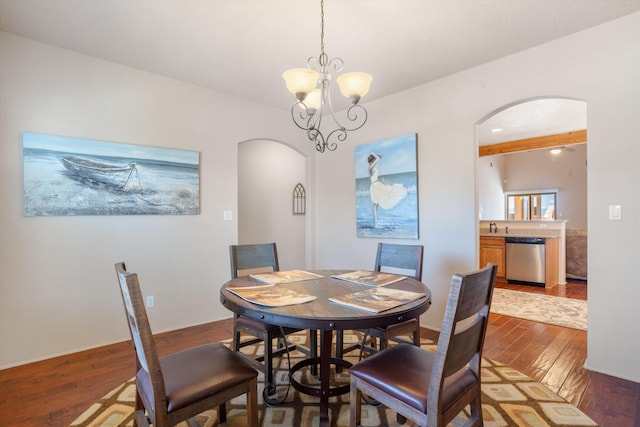 6615 Mountain Hawk Loop NE, Rio Rancho, NM 87144 - dining room with arched walkways, hardwood / wood-style flooring, and a chandelier